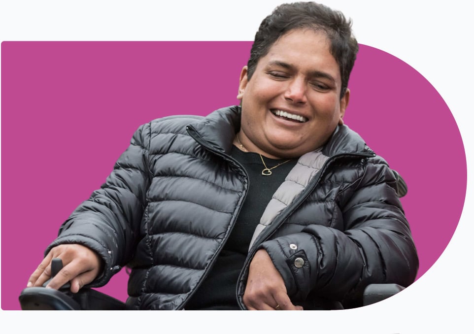 Client in a wheelchair laughing