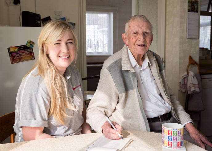 A smiling Carer with a client after starting a Care Worker job
