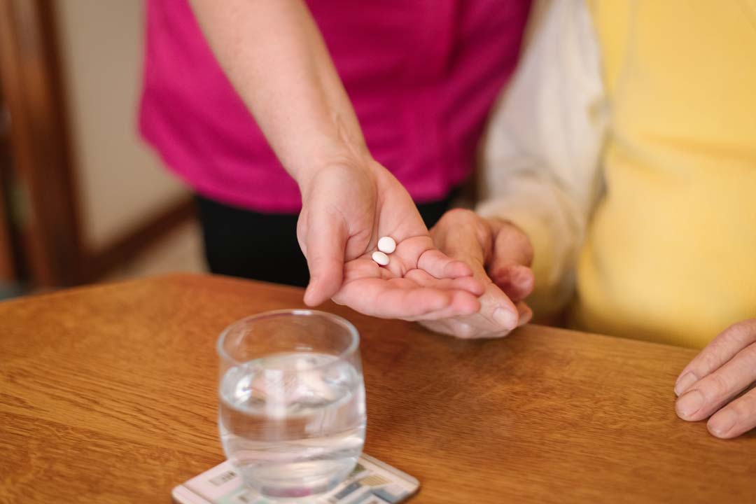Home Carer supporting a client with medication management
